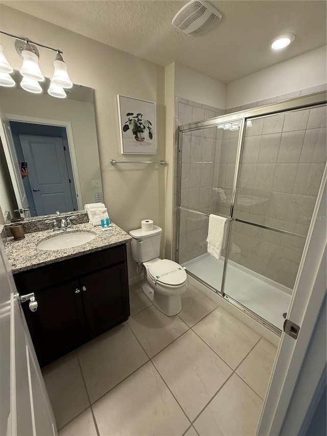 197 Jetty Way, Davenport, FL 33897 - bathroom featuring a stall shower, tile patterned flooring, toilet, and vanity