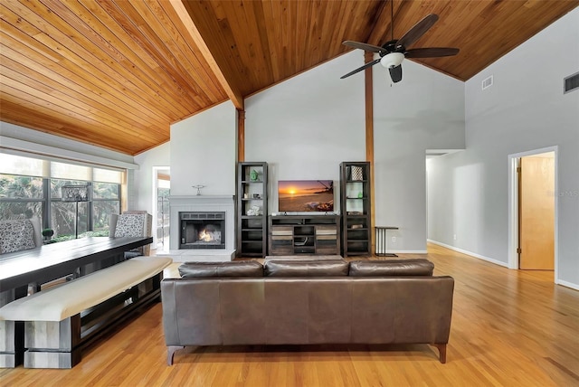 9503 Alice Ln, Riverview, FL 33578 - living area with wood ceiling, high vaulted ceiling, ceiling fan, a lit fireplace, and light wood-type flooring