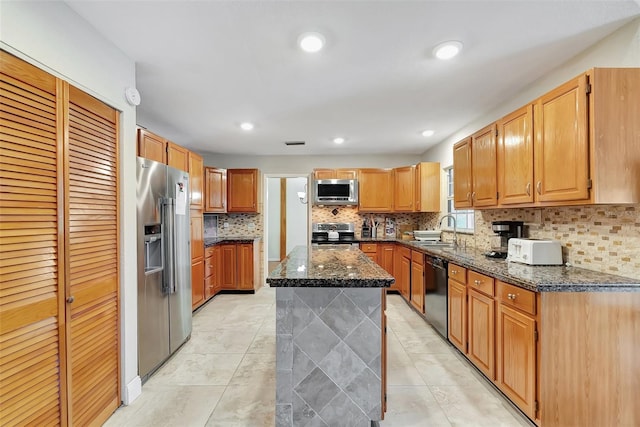 9503 Alice Ln, Riverview, FL 33578 - kitchen featuring stainless steel appliances, dark stone countertops, tasteful backsplash, a kitchen island, and light tile patterned flooring