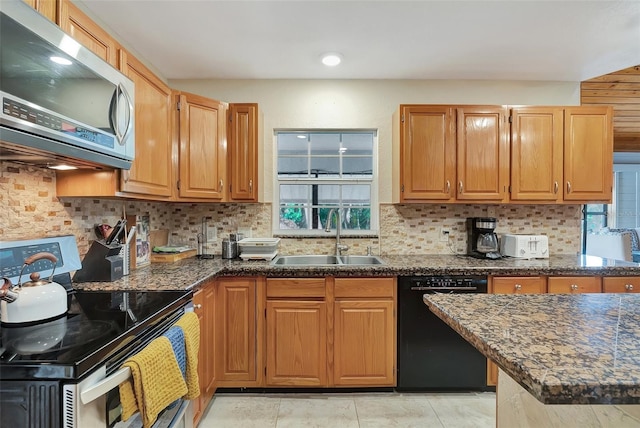 9503 Alice Ln, Riverview, FL 33578 - kitchen featuring appliances with stainless steel finishes, healthy amount of natural light, decorative backsplash, and dark stone countertops