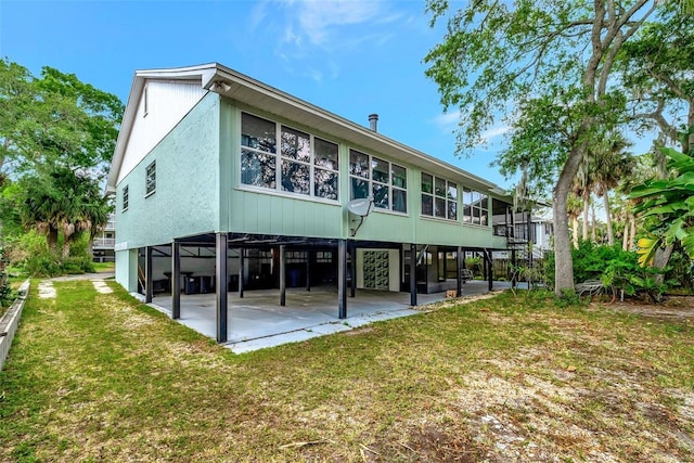 9503 Alice Ln, Riverview, FL 33578 - rear view of property featuring a lawn and a patio