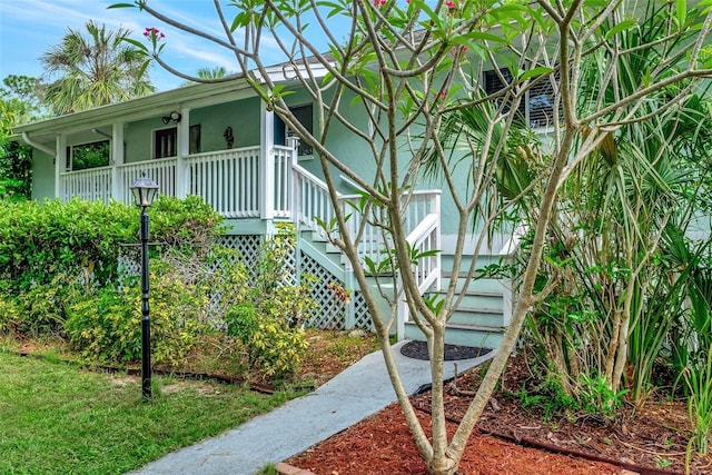 9503 Alice Ln, Riverview, FL 33578 - view of side of home with covered porch, stairway, and stucco siding