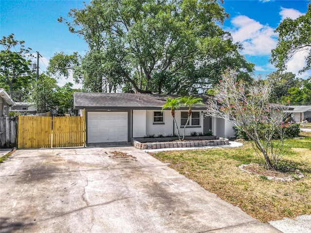 1298 Scottsdale Dr, Ormond Beach, FL 32174 - ranch-style home with fence, an attached garage, stucco siding, a front yard, and driveway