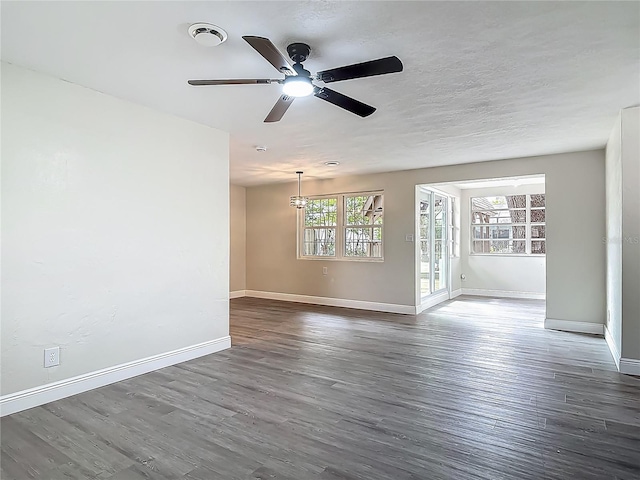1298 Scottsdale Dr, Ormond Beach, FL 32174 - spare room with baseboards, dark wood-style flooring, and visible vents