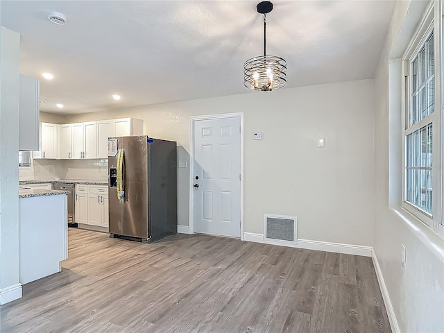 1298 Scottsdale Dr, Ormond Beach, FL 32174 - kitchen featuring light wood-style floors, baseboards, white cabinets, and stainless steel appliances
