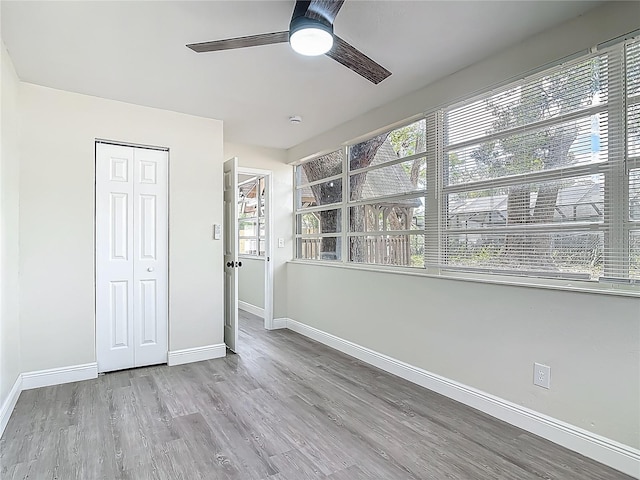 1298 Scottsdale Dr, Ormond Beach, FL 32174 - unfurnished bedroom with baseboards, wood finished floors, and multiple windows
