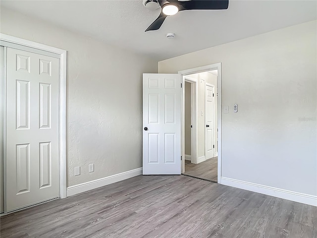 1298 Scottsdale Dr, Ormond Beach, FL 32174 - unfurnished bedroom with baseboards, ceiling fan, wood finished floors, and a closet