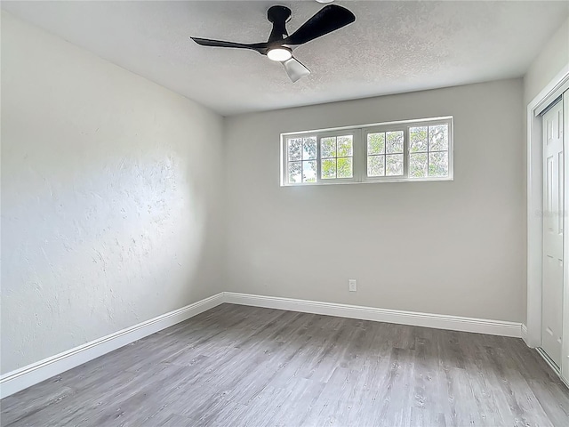 1298 Scottsdale Dr, Ormond Beach, FL 32174 - empty room featuring baseboards, a textured ceiling, ceiling fan, and wood finished floors