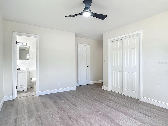 1298 Scottsdale Dr, Ormond Beach, FL 32174 - unfurnished bedroom with baseboards, ensuite bathroom, a closet, and light wood finished floors