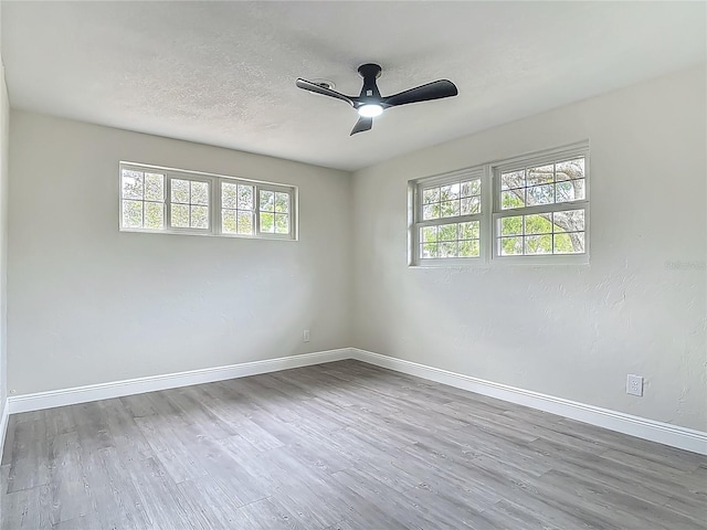 1298 Scottsdale Dr, Ormond Beach, FL 32174 - empty room featuring plenty of natural light, a ceiling fan, and wood finished floors