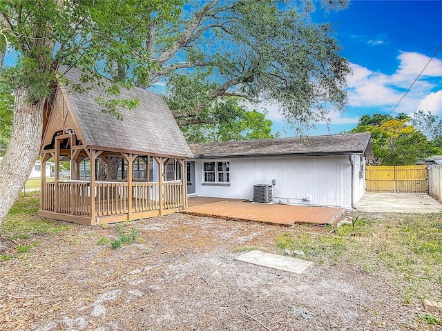 1298 Scottsdale Dr, Ormond Beach, FL 32174 - back of house with fence, a wooden deck, and central AC