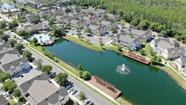 aerial view featuring a residential view, a view of trees, and a water view