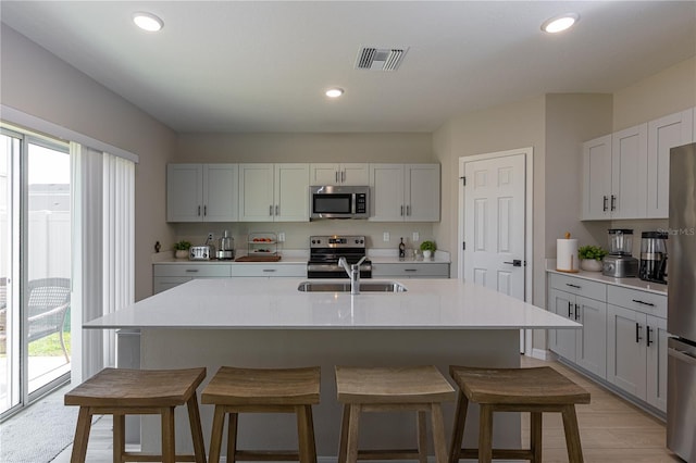 kitchen with a sink, a wealth of natural light, stainless steel appliances, and visible vents