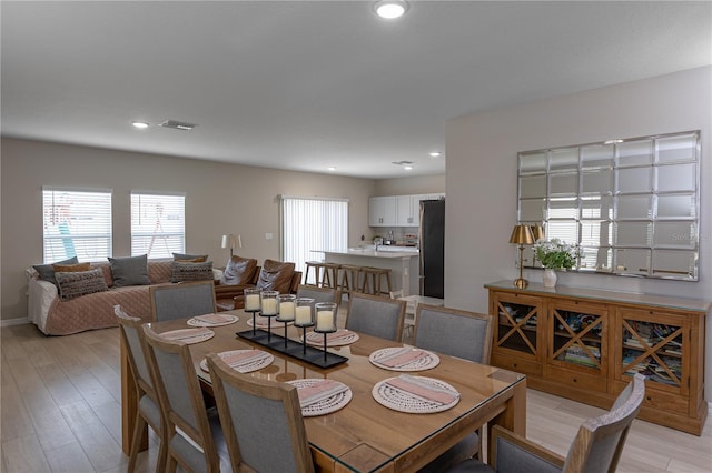 dining area with recessed lighting, visible vents, and light wood-style flooring