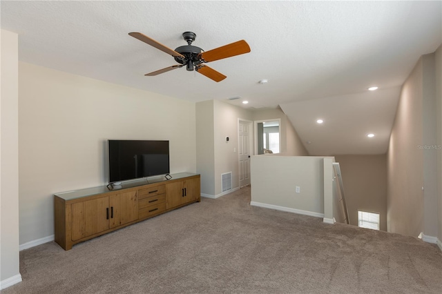 unfurnished living room featuring visible vents, baseboards, and light carpet