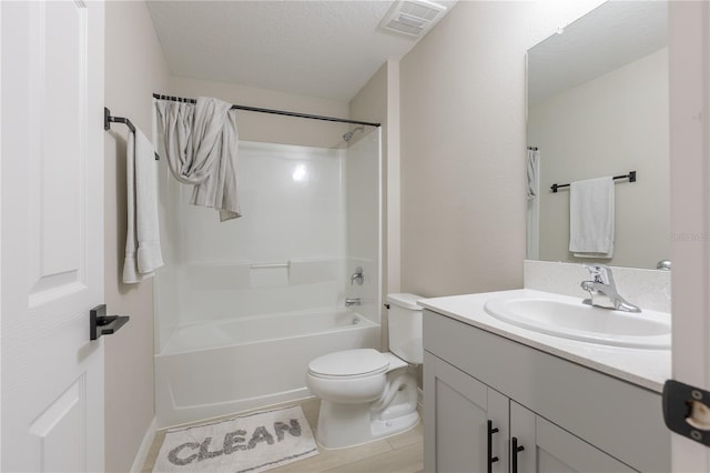 bathroom with vanity, shower / tub combination, visible vents, and toilet