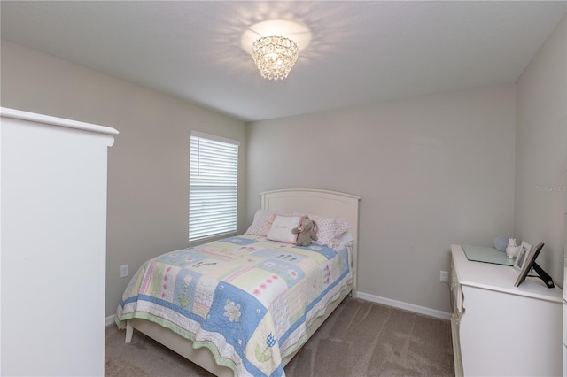 bedroom featuring carpet floors, baseboards, and a chandelier