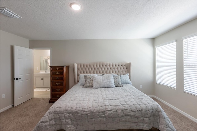 bedroom featuring visible vents, a textured ceiling, carpet, and baseboards