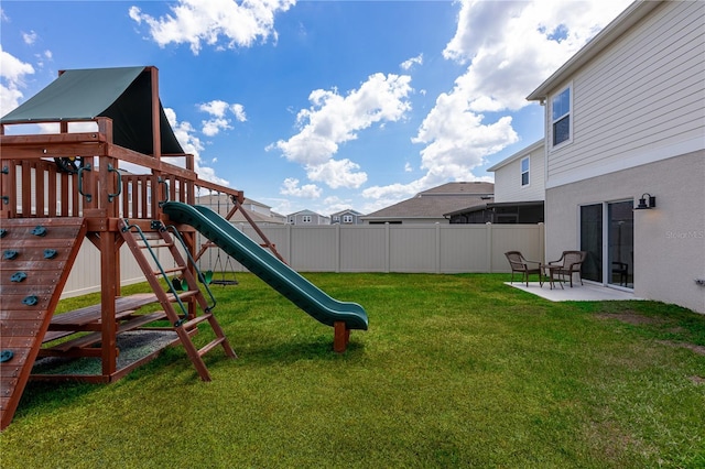 view of yard with fence, a patio, and a playground