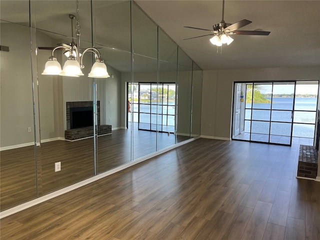 4109 Fairview Vista Pt Unit 315, Orlando, FL 32804 - unfurnished living room with a brick fireplace, baseboards, ceiling fan, high vaulted ceiling, and dark wood finished floors