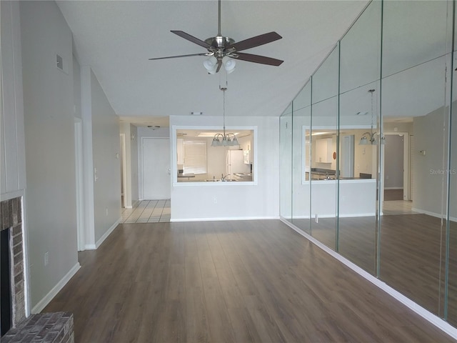 4109 Fairview Vista Pt Unit 315, Orlando, FL 32804 - unfurnished living room with baseboards, ceiling fan, vaulted ceiling, and wood finished floors