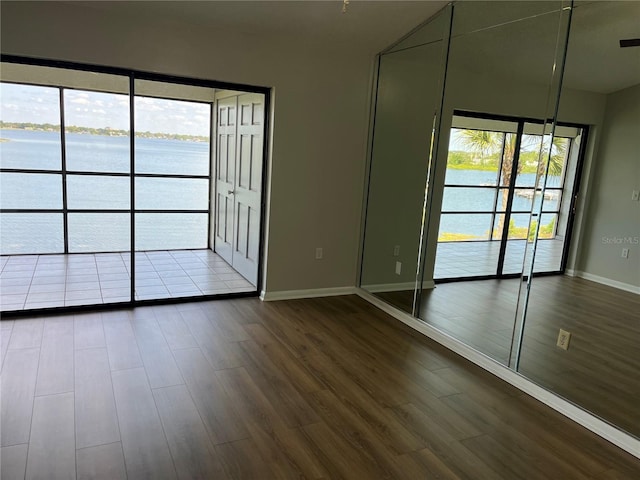 4109 Fairview Vista Pt Unit 315, Orlando, FL 32804 - spare room with a water view, baseboards, and dark wood finished floors