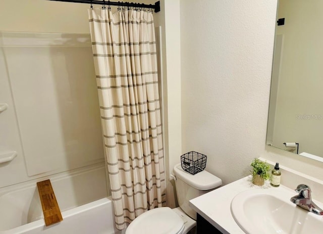bathroom with shower / bathtub combination with curtain, vanity, and toilet