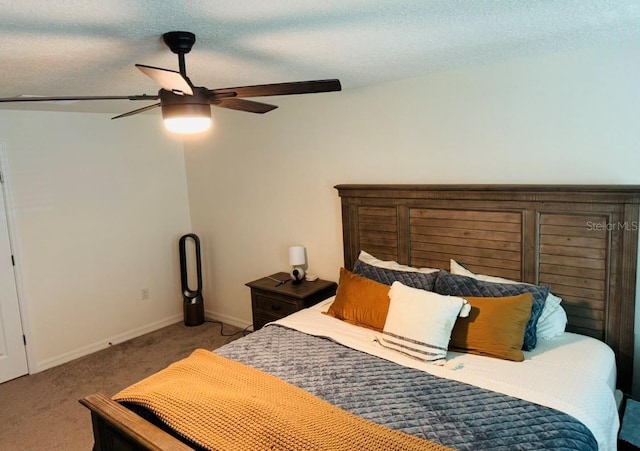 carpeted bedroom with baseboards and a ceiling fan
