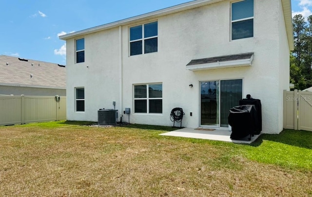 rear view of property with stucco siding, central AC, and a gate