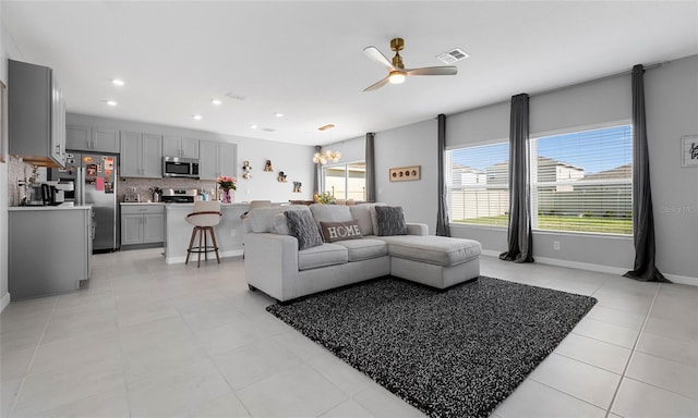 living room featuring ceiling fan, recessed lighting, light tile patterned floors, and baseboards