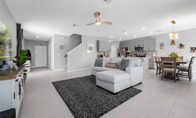 living room featuring light tile patterned flooring, stairs, a ceiling fan, recessed lighting, and baseboards