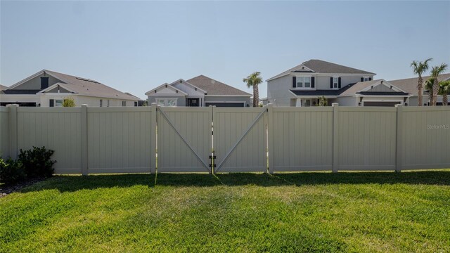 view of yard featuring a gate and a residential view