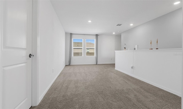 unfurnished room with recessed lighting, light colored carpet, and baseboards