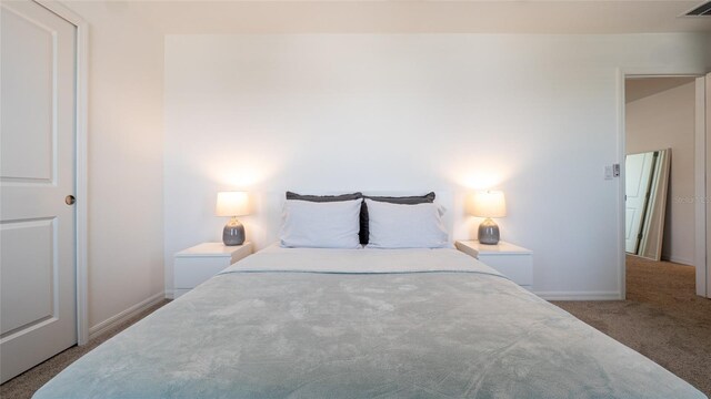 bedroom with carpet flooring and baseboards