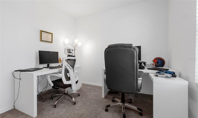 carpeted home office featuring baseboards