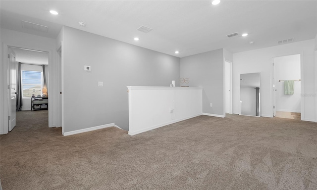 carpeted empty room featuring recessed lighting and baseboards