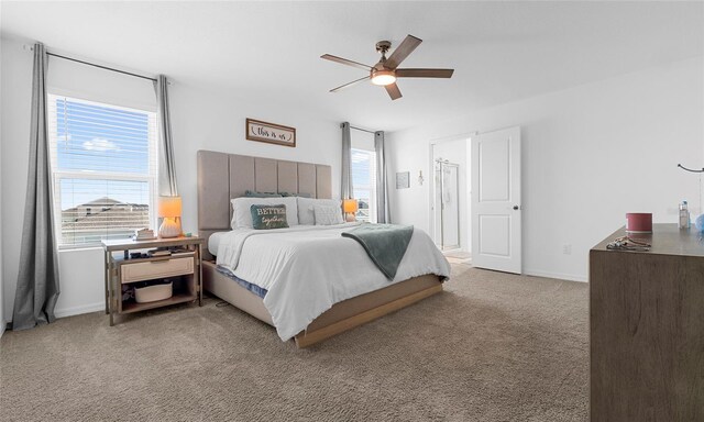 carpeted bedroom featuring baseboards and ceiling fan