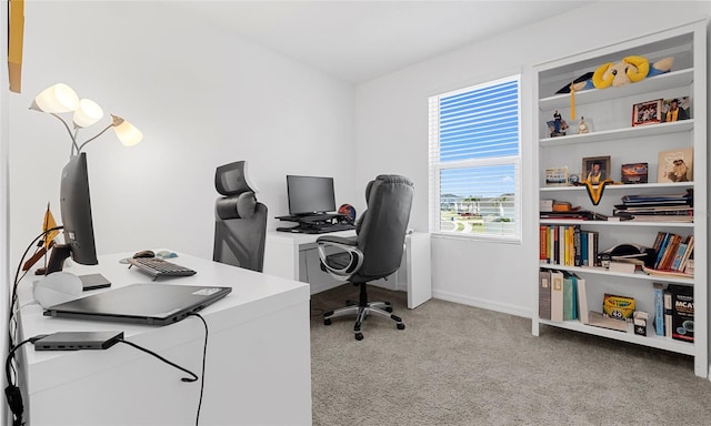 home office with light carpet and baseboards