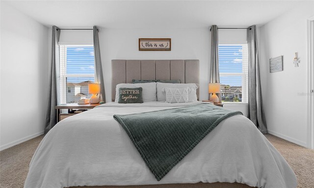 carpeted bedroom with multiple windows and baseboards