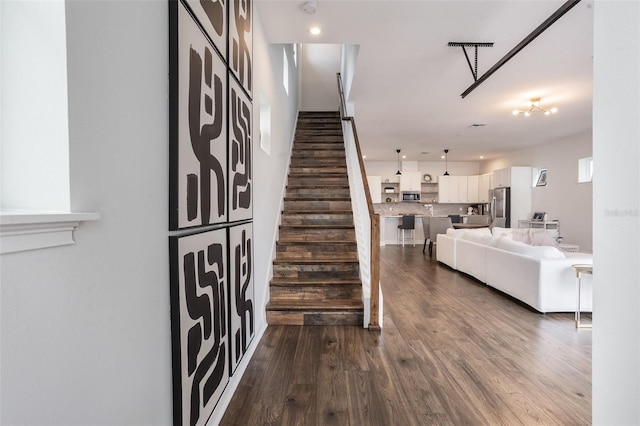 stairway featuring wood finished floors