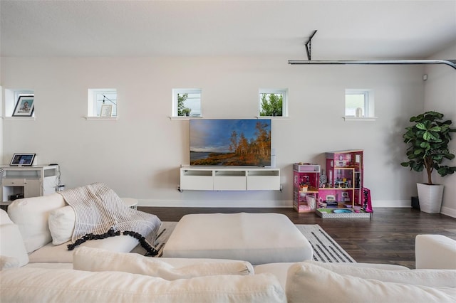 living room featuring baseboards and wood finished floors
