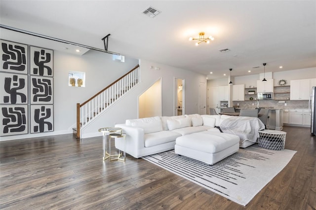 living area featuring stairs, recessed lighting, visible vents, and dark wood-style flooring