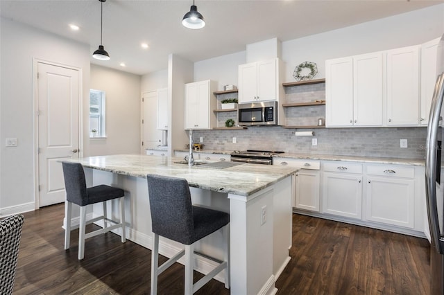 kitchen featuring appliances with stainless steel finishes, open shelves, and white cabinetry