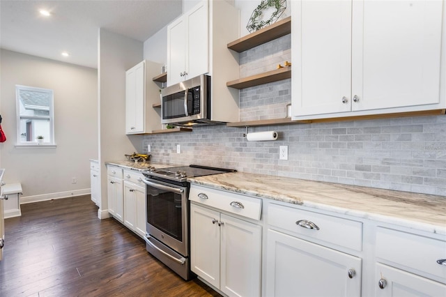 kitchen with open shelves, appliances with stainless steel finishes, light stone countertops, white cabinetry, and dark wood-style floors
