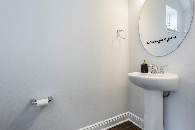 bathroom featuring baseboards and wood finished floors