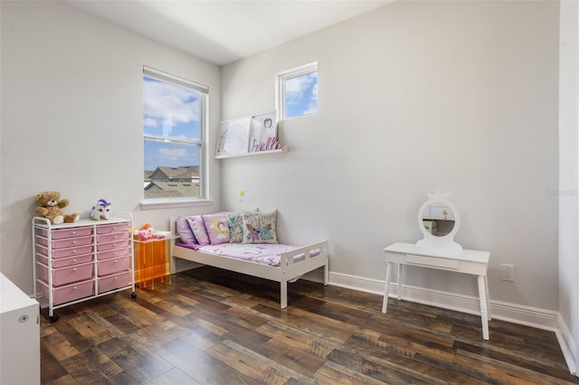 bedroom with baseboards and wood finished floors