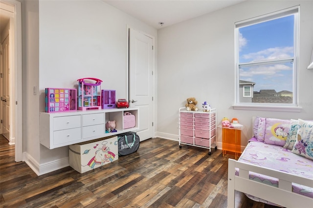 bedroom featuring baseboards and dark wood-style floors