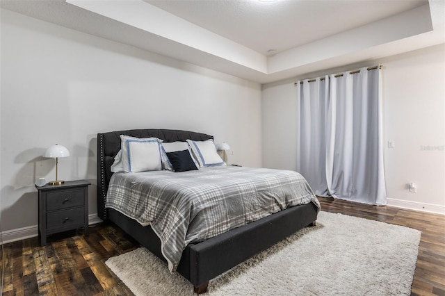 bedroom featuring baseboards and wood finished floors