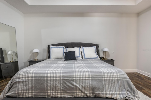 bedroom featuring baseboards and wood finished floors