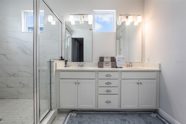 bathroom with double vanity, plenty of natural light, a sink, and a stall shower